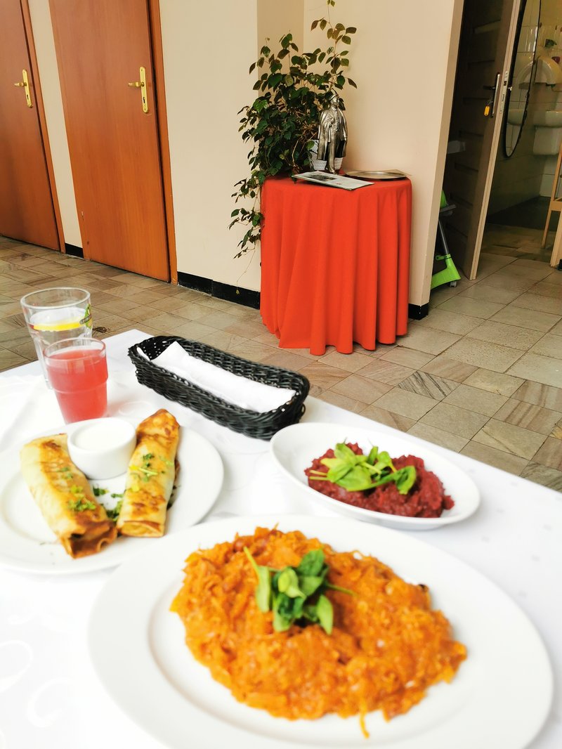 Nowa Huta restaurant table with view of statue